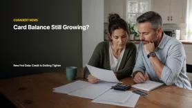 Household reviewing credit card statements and bills as a growing card balance meets tighter credit standards